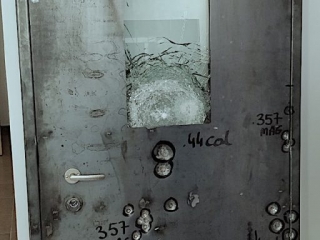 Internal steel construction of bullet resistant door after shooting test.