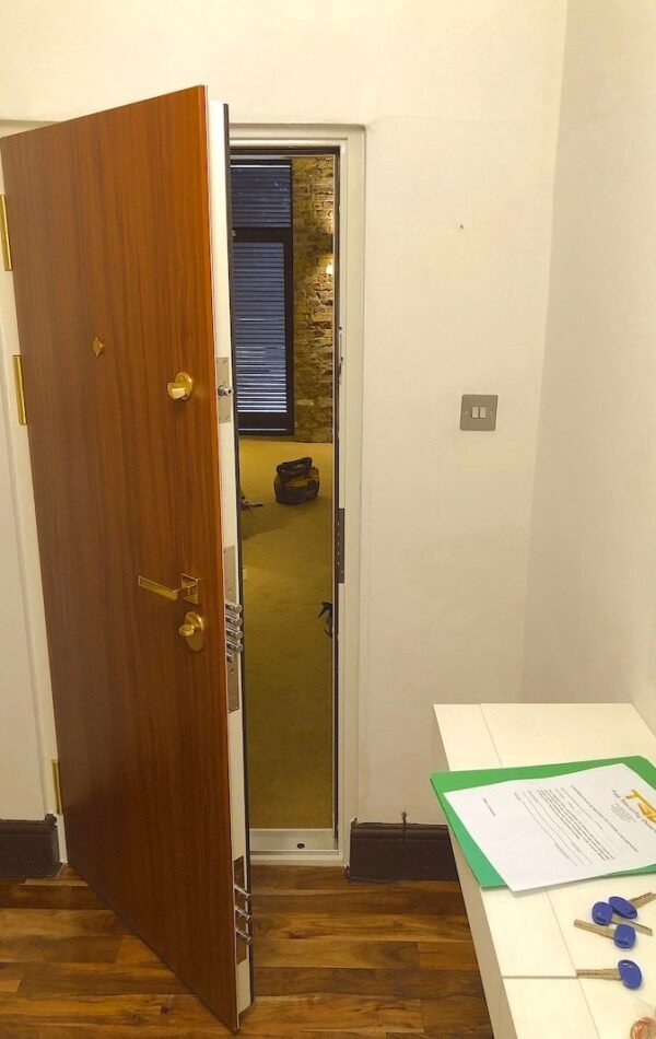 Beautiful security door in plain design, laminated in walnut with additional MOTTURA bolts for the lock.